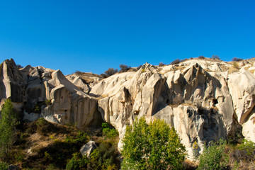 Rock formations in Goreme Open Air Museum. Most popular and famous place in Cappadocia, Turkey. Sunny day, clear blue sky 