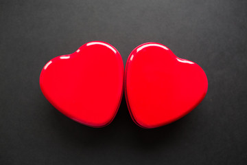 Fototapeta premium Valentines day background. Couple of hearts isolated on black.