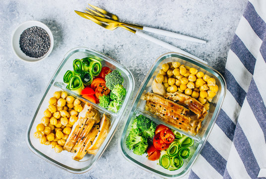 Healthy meal prep containers chicken and fresh vegetables.
