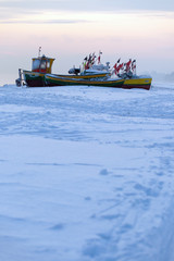 Podmorskie region, Poland - December, 2010: fishing boats on frozen beach, Baltic sea near Sopot town