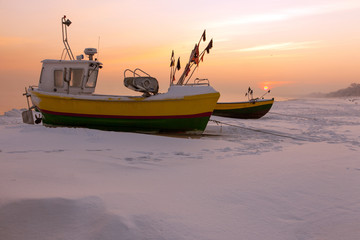 Podmorskie region, Poland - December, 2010: fishing boats on the beach in the winter, Baltic sea near Sopot town