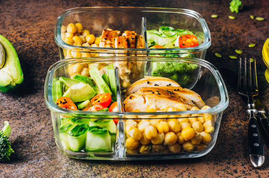 Healthy meal prep containers chicken and fresh vegetables.