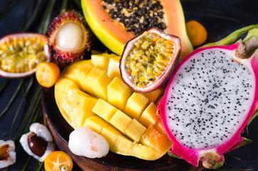 Mix of ripe tropical fruits with mango, dragon fruit, passion fruit, kumquat, papaya and lychee....