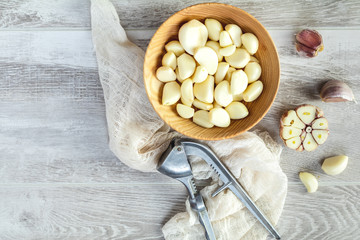 Fototapeta na wymiar Fresh garlic heads, cloves set on a light gray wooden surface