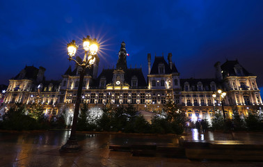 Fototapeta na wymiar The city hall of Paris decorated with Christmas trees at night. Paris, France.