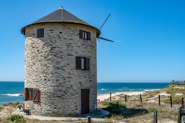 Old traditional wind-mills in sand-hills of Apulia Portugal
