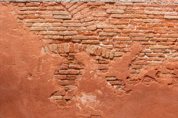 An old red brick wall in Venice, Italy.