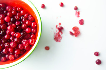 Raw Red Cranberries in a Bowl on the white background with berries