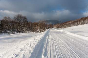 Fototapeta na wymiar Snowy road in Bieszczady, Bieszczady Mountains, Bieszczady National Park, Carpathians Mountains, Poland