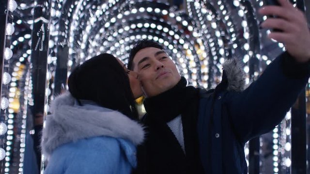 Young diverse mixed couple taking a selfie together, in slow motion