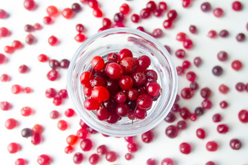 Top view. raw red cranberries in a glass