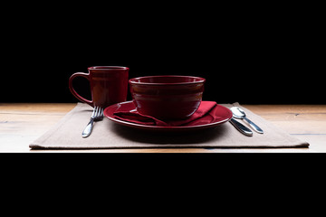 Dinner plate on wooden table with black background.
