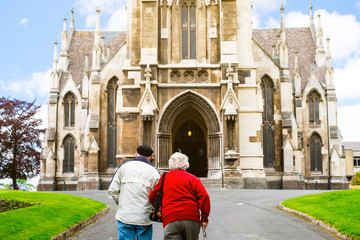 Two older go to the Cathedral together. St Joseph's Cathedral, Dunedin, New Zealand.