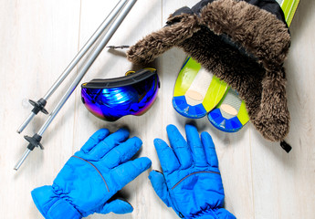 Ski equipment. Items included ski, goggles, gloves and ski sticks. Top view