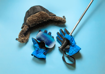 Ski equipment. Items included ski, goggles, gloves and ski sticks. Top view