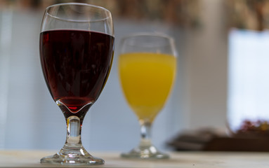 Two drinks on a counter in front of a window.