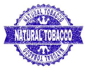 NATURAL TOBACCO rosette seal watermark with distress texture. Designed with round rosette, ribbon and small crowns. Blue vector rubber watermark of NATURAL TOBACCO text with scratched texture.