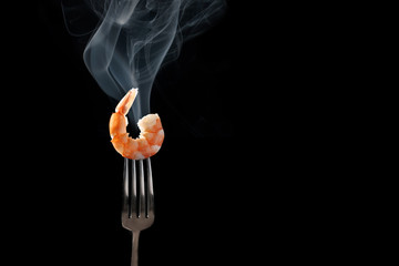 shrimp on fork isolated black background
