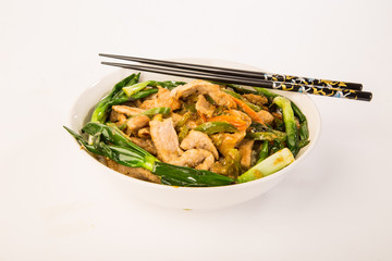 Pork Stir Fry over Steamed Rice with Chopsticks against White BG
