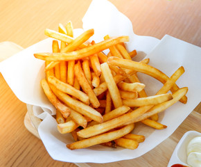 French fries on basket with cream and tomato sauce / Crispy potato fresh fries ketchup sauce for...