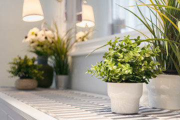 Fototapeta na wymiar Artificial flower vase decoration in modern Living room. Detailed of modern living room interior design with artificial plants in flowerpots.