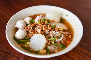 Spicy pork noodle soup with lemongrass chilly pasted and lime juice delicious noodles bowl with meatball pork slice peanut