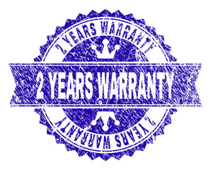 2 YEARS WARRANTY rosette seal imitation with distress texture. Designed with round rosette, ribbon and small crowns. Blue vector rubber watermark of 2 YEARS WARRANTY tag with corroded texture.