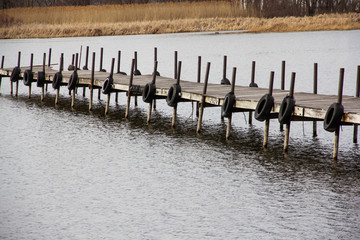 wooden dock with tires on a lake