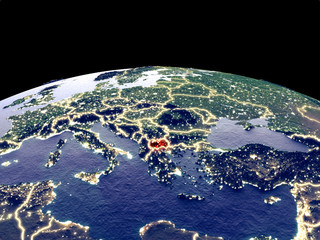 Macedonia from space on planet Earth at night with bright city lights. Detailed plastic planet surface with real mountains.