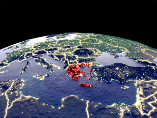 Greece from space on planet Earth at night with bright city lights. Detailed plastic planet surface with real mountains.