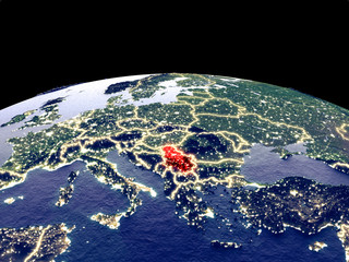 Serbia from space on planet Earth at night with bright city lights. Detailed plastic planet surface with real mountains.