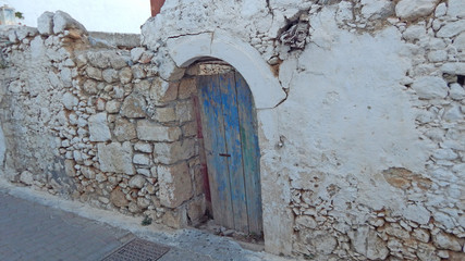 old wall with arched door