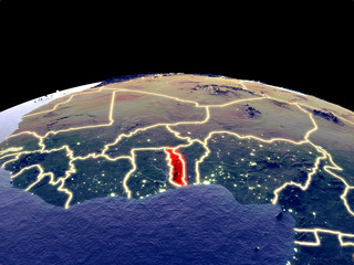 Togo from space on planet Earth at night with bright city lights. Detailed plastic planet surface with real mountains.