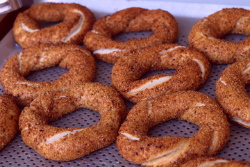 Ruddy bagels with sesame on the buffet. Cropped shot, close-up, horizontal, side view. The concept of food and service.
