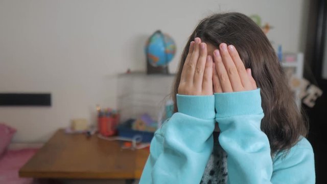 peek a boo. little girl covered her eyes face with her hands hide-and-seek waiting for a surprise. slow motion video. teen girl playing bo-peep. childhood concept game lifestyle hy - spy
