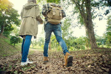 man and woman walk in the forest