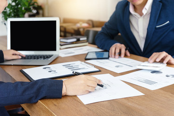 Businessman and staff working with computer on table