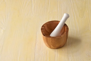 Wooden mortar on rustic background 