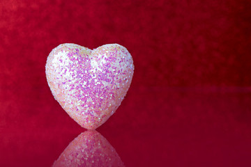 Pink heart on red background