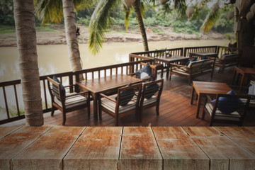 wood walk way with coffee bar beside river.