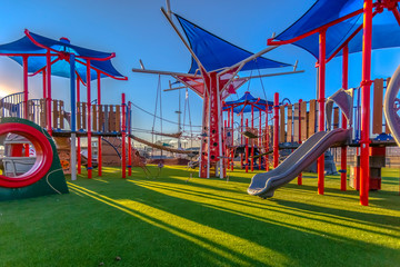 Sun light cast on playground red and blue colors
