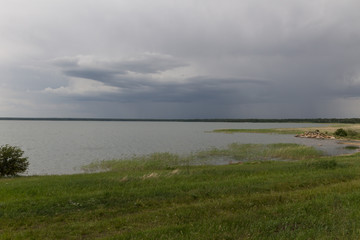 landscape with lake and dark sky