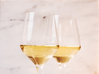 two wine glasses on marble top 
