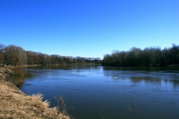 Fototapeta na wymiar River banks. Water and trees. Springtime.