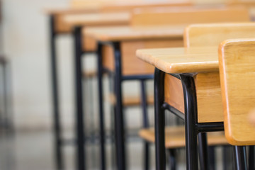 Lecture room or School empty classroom with desks chair iron wood for studying lessons in high school Thailand, interior of secondary education no kid teacher or young student, Vintage tone
