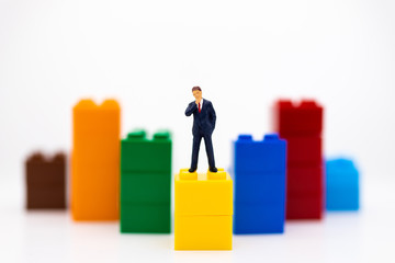 Miniature people: Businessman stand front of dashboard, display graphs, profit margins of ...