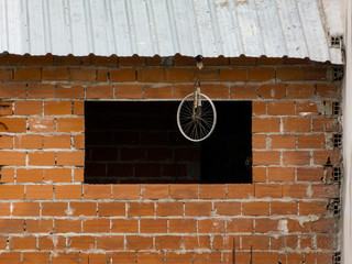 Bike wheel weird decoration outside a construction