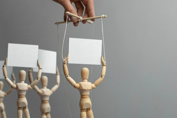Provocateur puppet activist is calling people to protest. Hand-held puppet doll on the ropes and...