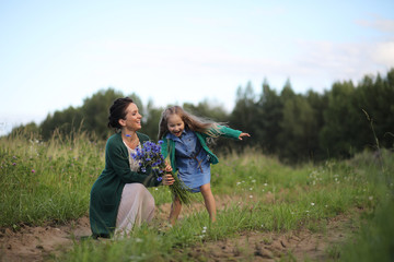 Mother with daughter walking on a road