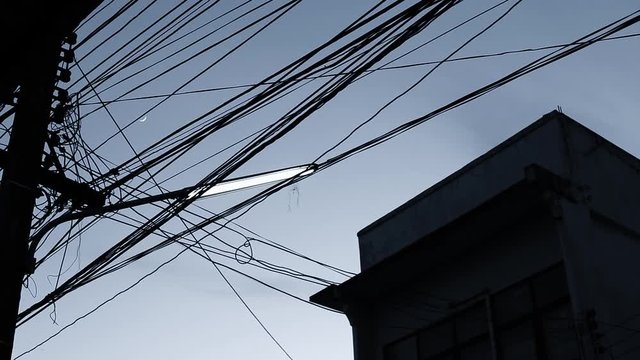 Silhouette Tangles of power, telecom and other types of cable are a familiar sight in Thailand